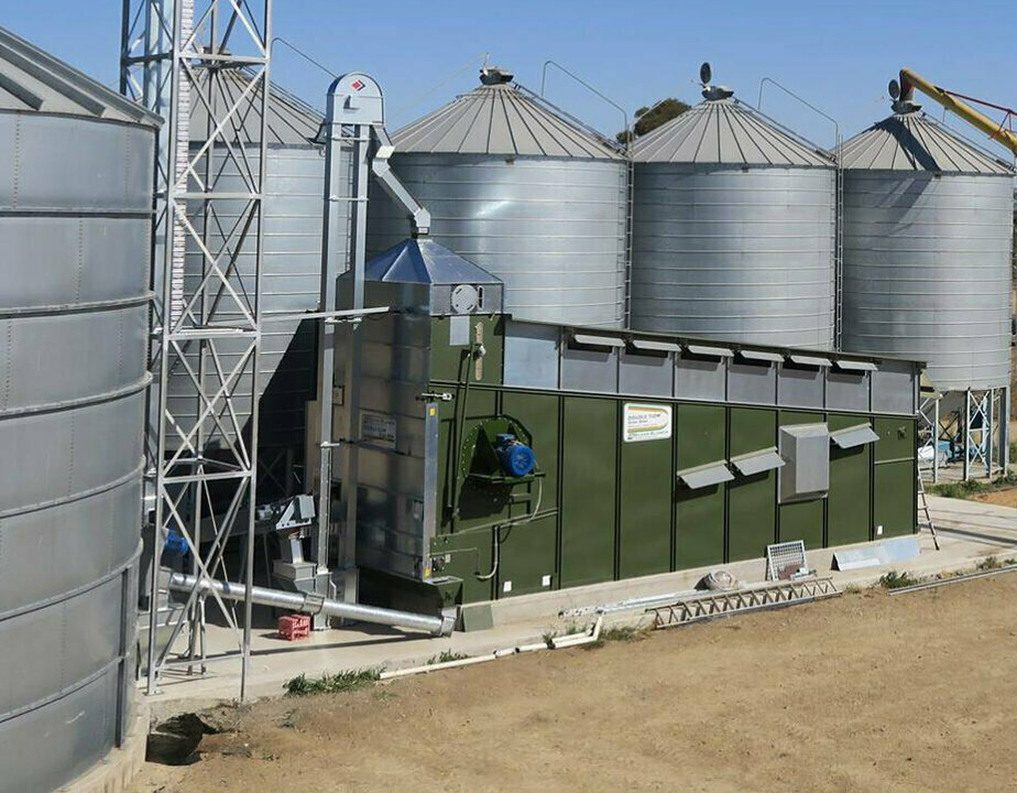 An Alvan Blanch grain dryer sits in front of 5 feed silos